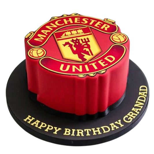 Custom Manchester United cake with edible player/mascot topper in full kit, celebrating club pride in edible glory.

